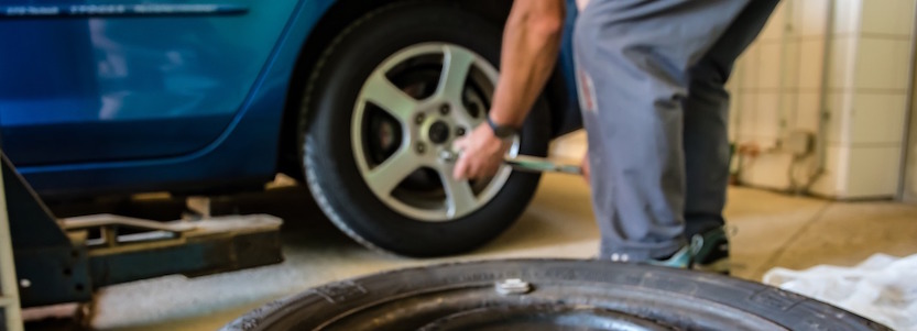 man repairing car