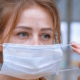 Woman putting on medical mask