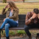 A couple on a bench looking sad and separated