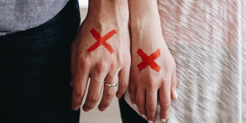 red exes on hands