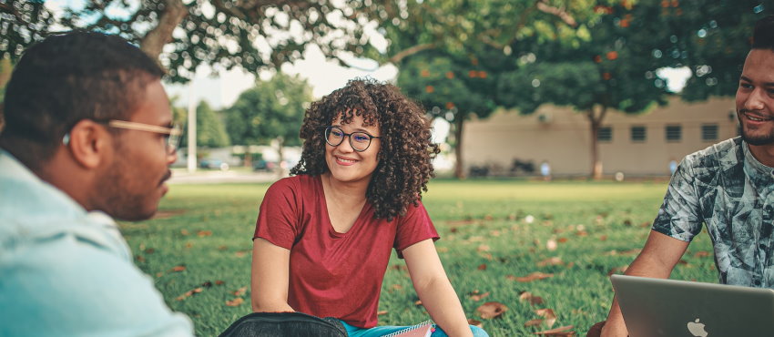 students sitting on grass