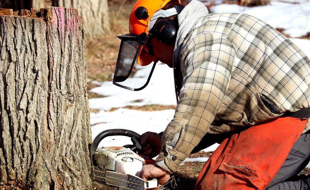 man using a chainsaw