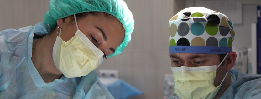 Two doctors in full scrubs