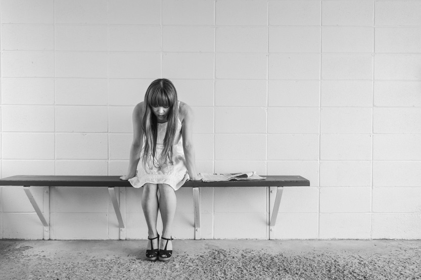 worried woman sitting on bench